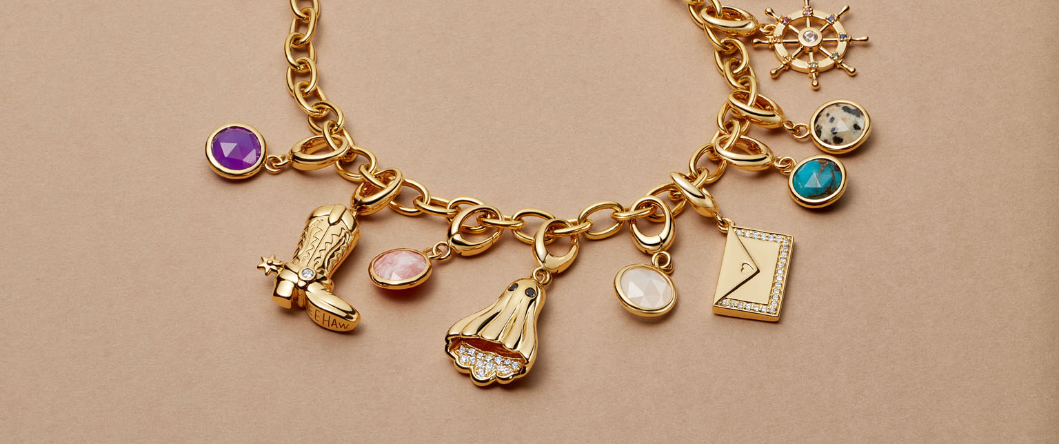 Gold jewelry stack with engraved locket
